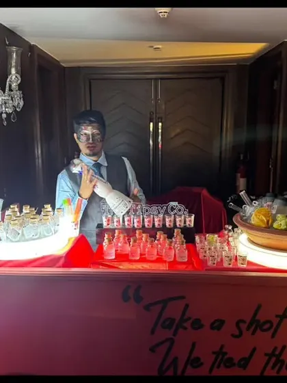 A custom shot bar with a sign that reads 'Take a shot, we tied the knot'. It's a fun and personal touch that encourages guests to celebrate the newlyweds.