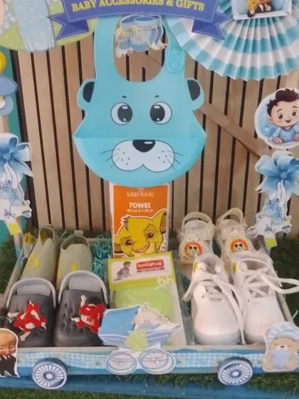 The 'Baby Accessories & Gifts' carriage, packed with baby shoes, bibs, and towels.