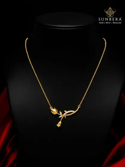 A delicate rose crafted in 22K gold, this necklace is a symbol of timeless love. The design features a blooming rosebud on a gently curved stem, accented with small diamonds for a touch of sparkle.