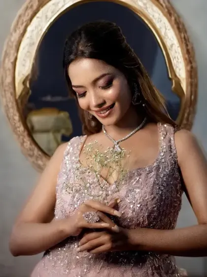 A lovely bridal portrait where the bride is admiring her ring. The soft lighting and her gentle smile create a sweet and contemplative moment.