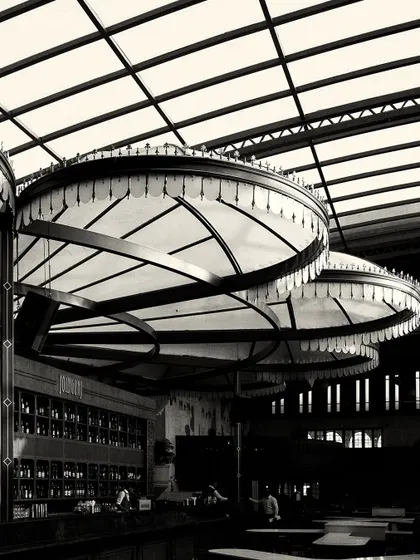 A close-up of the custom canopy lights over the bar. The fringe detail and radial structure are key design elements that contribute to the Calcutta-inspired theme.