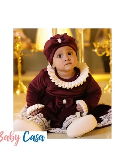 Another angle of this gorgeous maroon velvet dress. The matching cap and booties complete the look, making it a standout piece from my winter collection.