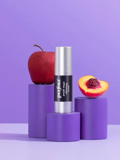 A product-focused shot for Perfora's "Purple Magic" serum. The composition uses purple blocks and fresh fruit ingredients to explain the product's formulation in a simple, visual way.