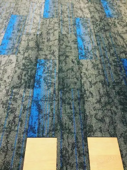 This shows carpet tile installation in progress for a commercial office space. These tiles are durable, easy to replace, and great for creating custom patterns in high traffic areas.