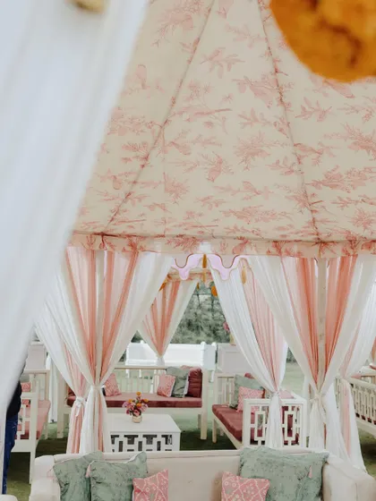 A peek inside the custom-printed tents for Preeat's Chooda ceremony. The combination of the floral print, soft draping, and comfortable seating created an intimate and welcoming space for the family gathering.