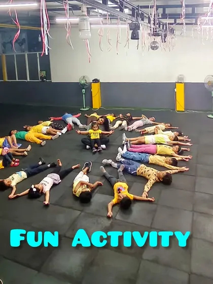 Fun activity time! Here, our students are creating a human sunburst on the floor. We mix our dance lessons with creative games and activities to keep things exciting.