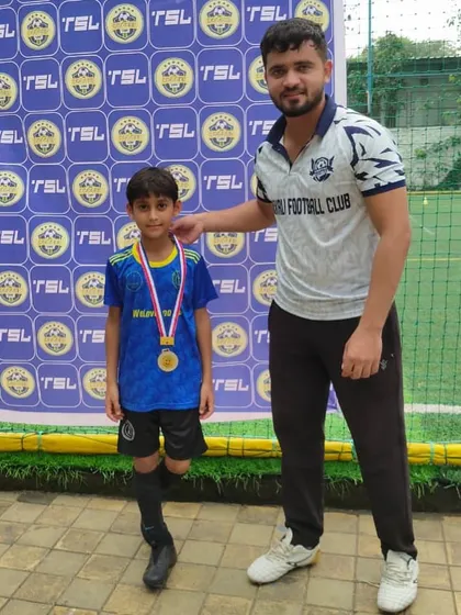 A proud coach with a deserving player. Our Head Coach, Siddhesh Tambekar, celebrating a U8 player's medal at a TSL event.