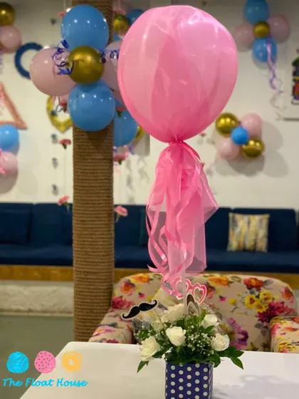 A close-up of the delicate decorations for a baby shower, including floral arrangements and themed balloons, showcasing our attention to detail.