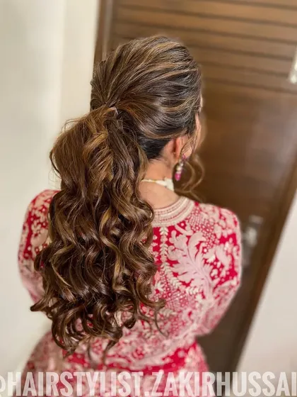 A chic and messy ponytail with lots of texture and volume. This is a great style for a relaxed and modern bride.