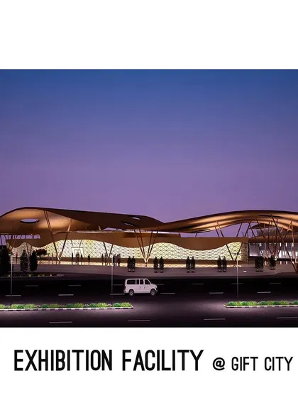 A nighttime rendering of the proposed exhibition facility at GIFT City, showing its massive, undulating roof illuminated against the sky.