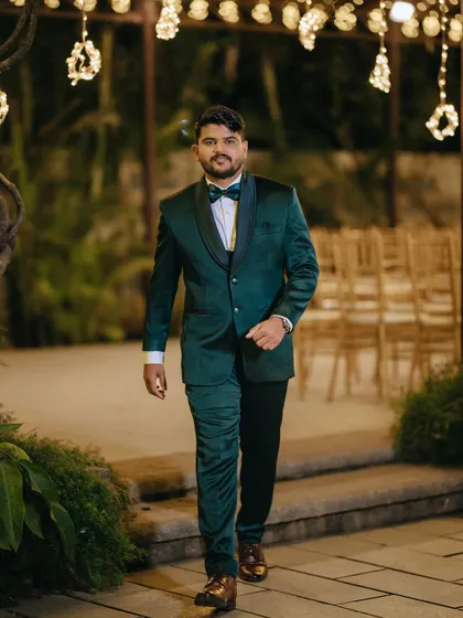 A stylish portrait of the groom arriving at his reception. The focus is on his sharp suit and confident walk, capturing his personality.