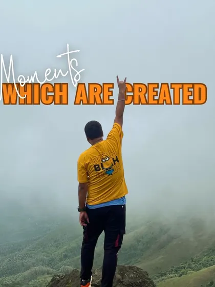 Moments which are created. A trekker celebrating on a misty peak, embodying the sense of freedom and achievement that our trips provide.