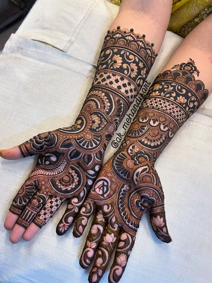 This beautiful full-hand bridal design includes personalized initials hidden within the intricate patterns on the palm.