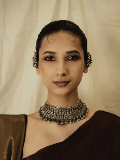 A clean and elegant beauty shot focusing on the traditional silver jewelry and flawless makeup. A perfect addition to a beauty portfolio.