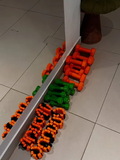 A colorful array of our yoga props, including ankle weights and dumbbells, ready for a yoga with weights class.