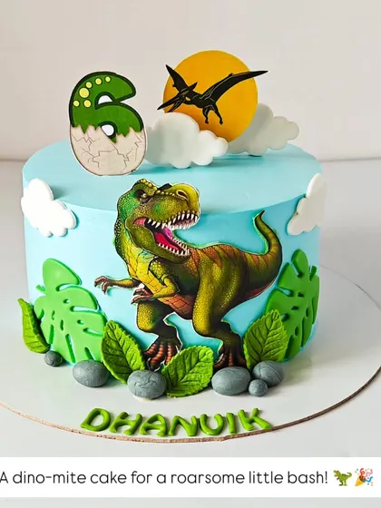 A dino-mite cake for a roarsome little bash. This dinosaur-themed cake features a T-Rex, edible leaves, and a cracked egg number '6' for a prehistoric party.