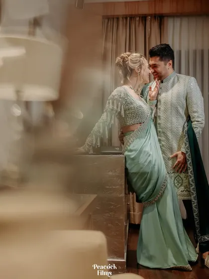 An intimate and artistic portrait of the couple. The soft focus and warm lighting create a dreamy, romantic atmosphere for their cocktail night.