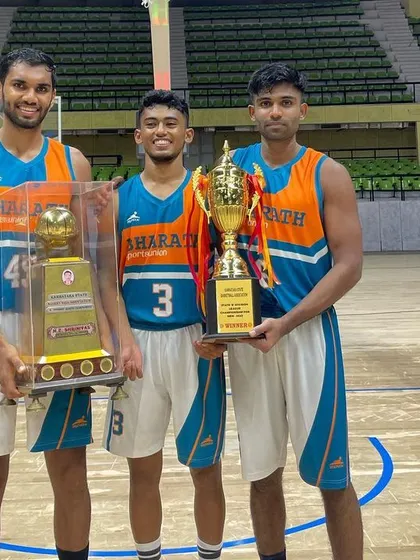 Teammates holding the championship trophies.