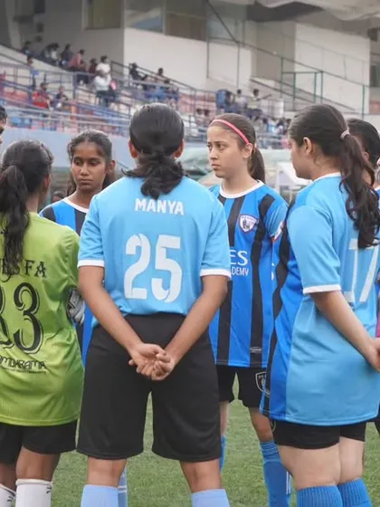A moment of focus as our women's team huddles up with their coach before a match against Red United Football Academy.