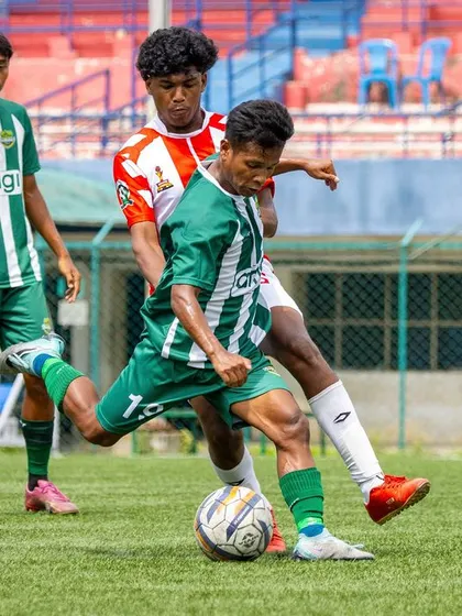 A player uses his strength to shield the ball while preparing to shoot, demonstrating power and technique under pressure.