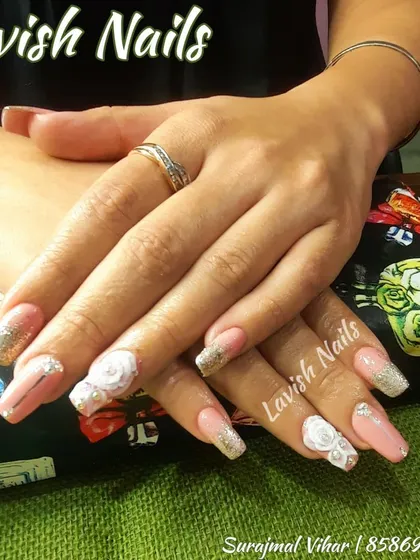 A full view of a luxurious bridal manicure, showcasing 3D roses and glitter accents that create a cohesive and high-impact design.
