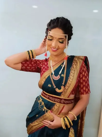 The complete look for my Maharashtrian bride, showcasing her beautiful 'nauvari' saree and traditional jewelry. Her smile says it all, and achieving that happiness and confidence is what my bridal classes are all about.
