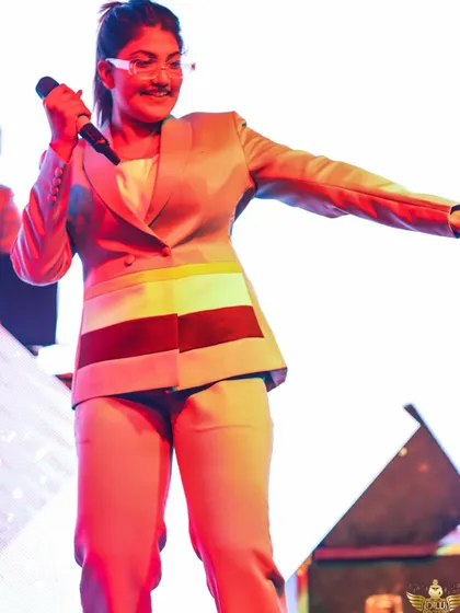 Our female vocalist, dressed in a stylish custom suit, ready to own the stage. We believe in looking as good as we sound.
