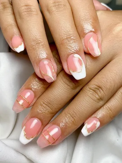 A touch of gold. This elegant French manicure is elevated with thin, carefully placed gold wire accents for a modern and artistic feel.