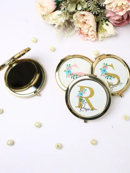Our stylish and handy personalized pocket mirrors. These feature a floral design with a custom name and initial, making them a perfect small gift or bridesmaid favor.
