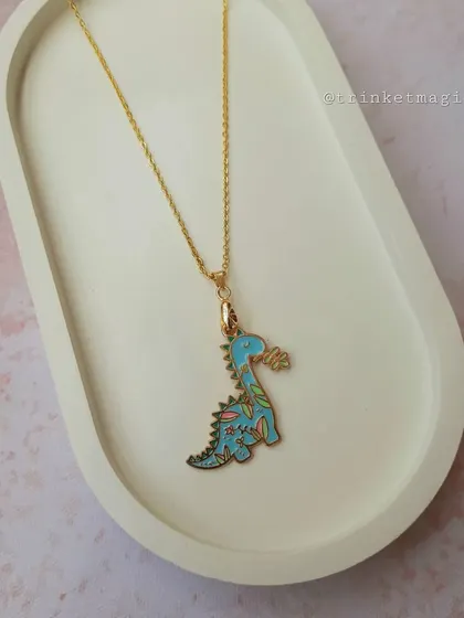 The popular dino charm necklace, featuring a blue dinosaur with a floral pattern. It's a fun mix of fierce and cute.