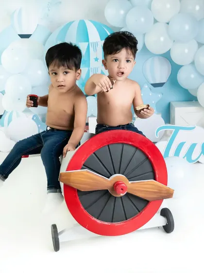 A fun and creative "two" year old birthday shoot for adorable twin boys, complete with an airplane prop and lots of personality.