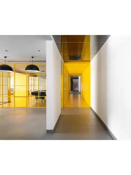 We are honored to have received a Commendation for Institutional and Public Space Interior at the IIID Design Excellence Awards for our project, 'The Amber Encase'. This view shows the dynamic interplay between the bright yellow game room and the neutral-toned corridor.