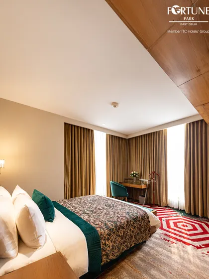 The geometric patterns of the rug complement the clean lines of the furniture in this room. Every element is chosen to create a visually pleasing and comfortable environment.