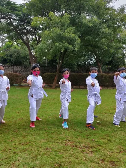 We love taking our practice outside. Here's a group of my students enjoying an outdoor karate session on the lawn. Getting fresh air while learning basic stances is a favorite part of our summer camp.