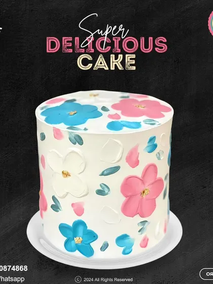 A beautiful and artistic floral cake. This design features hand-painted pink and blue flowers on a white buttercream canvas, creating a simple yet stunning look for any celebration.