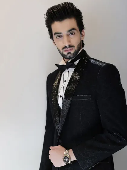 The full look of the black paisley tuxedo exudes confidence. It’s a modern, stylish choice for any formal event, from a wedding to a black-tie gala.