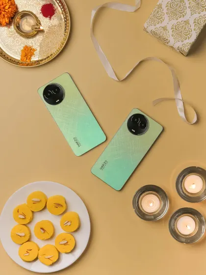 Another angle of the Diwali flatlay, showing two phones and creating a sense of abundance and celebration.