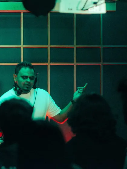 A silhouette shot of me gesturing to the crowd, taken from the dancefloor.