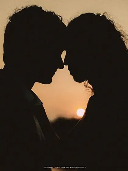 A beautiful silhouette of a couple against the setting sun. This is the epitome of a romantic, pre-wedding photograph.