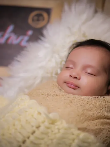A close-up portrait of a sleeping newborn, Kaashvi, highlighting her peaceful expression and delicate features.