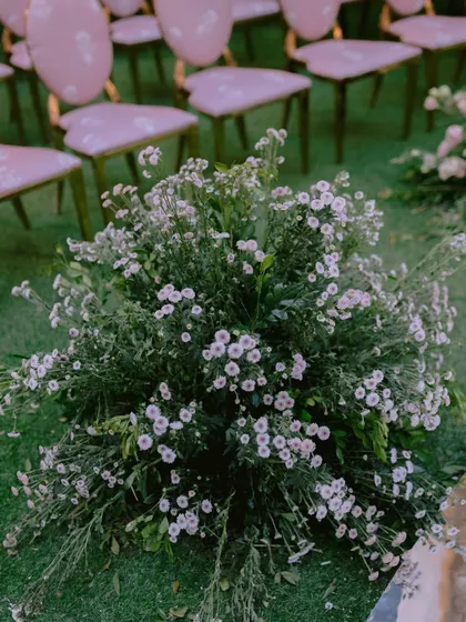 Another look at the floral details from the contemporary mandap. The wild, natural arrangement of flowers growing at the base of the installation grounds the modern design.