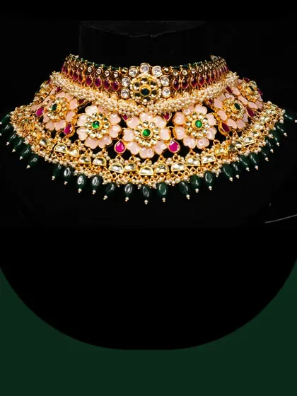 A floral-themed choker with pink and green enamel work, a delicate and feminine piece available for rent.
