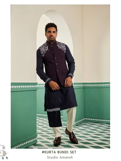 For an evening of elegance, we present this space blue bundi set. The deep tones of the bundi and kurta are highlighted by striking silver handwork on the shoulder and drape, a design made for engagements and cocktail parties.