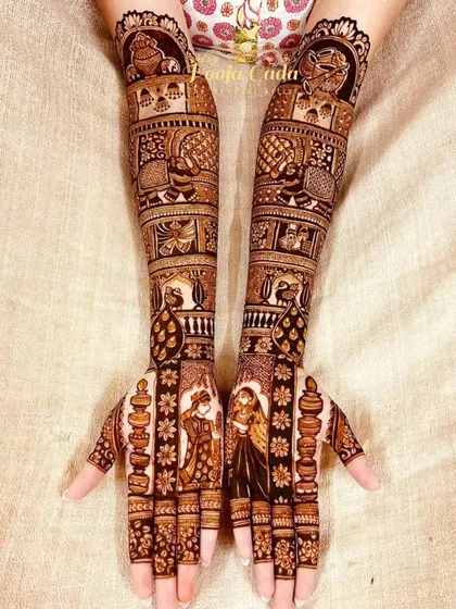 A heavy bridal design with diya (lamp) motifs lining the fingers, adding a unique and auspicious touch to the figurative work.