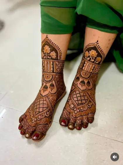 A beautiful and dense foot design that matches the style of full bridal hand mehndi. It features lotus flowers and intricate jaali (net) patterns.