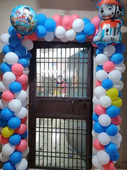 A colorful Paw Patrol themed balloon arch for a doorway. This decoration, featuring Marshall and Chase, is a great way to welcome guests to the party.