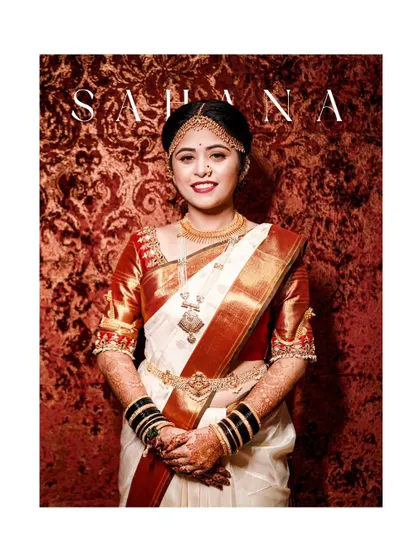 A classic and elegant bridal portrait, showcasing the bride's beautiful traditional attire and jewelry against a rich red backdrop.