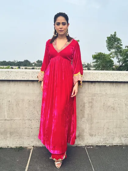 A full-length front view of the pink velvet suit, showcasing its flattering A-line silhouette.