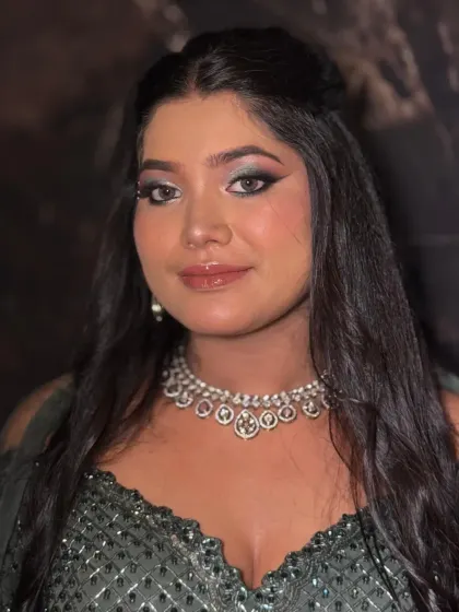 A direct portrait showing off the intense winged eyeliner and glossy lips of this full glam look.