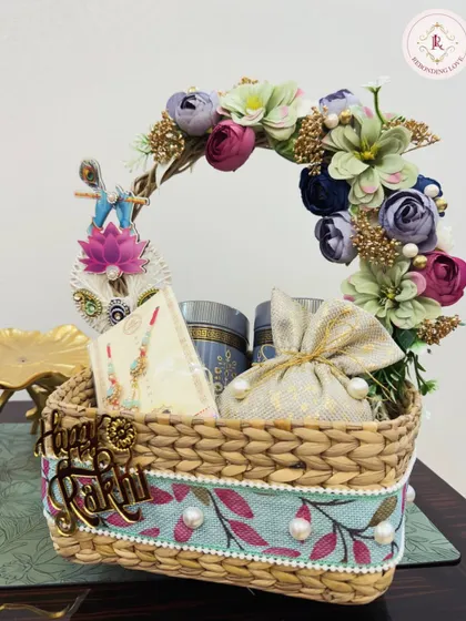 A side view of our floral handle Rakhi basket, showcasing the pearl and fabric details on the basket and the thoughtful gifts inside.